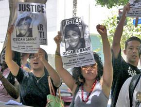 Protesters demand justice outside the courtroom where Grant's murderer went on trial